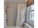 Bathroom featuring white subway tiles in shower and window overlooking a lake at 10815 Donamere Dr, Johns Creek, GA 30022