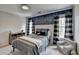 Well-lit bedroom with bold wallpaper, matching curtains, and a comfortable bed at 10815 Donamere Dr, Johns Creek, GA 30022