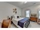 Bright bedroom with neutral decor, black metal frame bed, and hardwood floors at 10815 Donamere Dr, Johns Creek, GA 30022