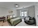 bedroom with dinosaur wallpaper, a large window and cozy beanbag at 10815 Donamere Dr, Johns Creek, GA 30022