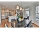 Open dining area with modern lighting fixtures and access to the kitchen at 10815 Donamere Dr, Johns Creek, GA 30022
