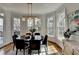 Bright dining room boasts hardwood floors, decorative windows, and stylish lighting fixtures at 10815 Donamere Dr, Johns Creek, GA 30022