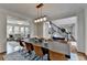 Open floorplan featuring dining area, staircase, and living room with comfortable seating at 10815 Donamere Dr, Johns Creek, GA 30022