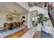 Dining room with modern lighting fixture, hardwood floors, and views into the living room at 10815 Donamere Dr, Johns Creek, GA 30022