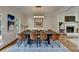 Dining area featuring a modern table, fireplace, and natural light from large windows at 10815 Donamere Dr, Johns Creek, GA 30022