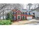 Beautiful two-story brick home with manicured landscaping and a welcoming entrance at 10815 Donamere Dr, Johns Creek, GA 30022