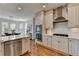 Bright kitchen boasts stainless steel appliances, double oven, quartz countertops, and hardwood floors at 10815 Donamere Dr, Johns Creek, GA 30022