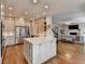 Open kitchen with island, stainless appliances, and views of the living area at 10815 Donamere Dr, Johns Creek, GA 30022