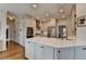 Well-lit kitchen with a large island, stainless steel appliances, and hardwood floors at 10815 Donamere Dr, Johns Creek, GA 30022