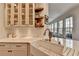 Farmhouse sink, bright white cabinets, wood shelving, and white subway tile give this kitchen a fresh, modern feel at 10815 Donamere Dr, Johns Creek, GA 30022