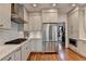 Modern kitchen with stainless steel appliances, white cabinets, and hardwood floors at 10815 Donamere Dr, Johns Creek, GA 30022