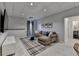 Basement living room with a cozy sectional sofa, TV, and plaid rug at 10815 Donamere Dr, Johns Creek, GA 30022