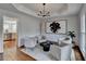 Bright living room featuring a black chandelier, abstract art, and lots of natural light at 10815 Donamere Dr, Johns Creek, GA 30022