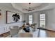 Bright living room with modern chandelier, abstract art, and wainscoting at 10815 Donamere Dr, Johns Creek, GA 30022