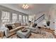 Cozy living room with large windows, comfortable seating, and stylish decor at 10815 Donamere Dr, Johns Creek, GA 30022
