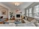 Spacious living room featuring a fireplace, ample natural light, and neutral decor at 10815 Donamere Dr, Johns Creek, GA 30022