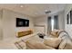 Basement living room with a comfortable sectional sofa, TV, and plaid rug at 10815 Donamere Dr, Johns Creek, GA 30022