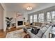 Cozy living room with fireplace, large windows, and comfortable seating area at 10815 Donamere Dr, Johns Creek, GA 30022