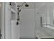 Updated shower featuring a glass enclosure and convenient built-in shelving for storage at 10815 Donamere Dr, Johns Creek, GA 30022