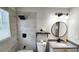 Updated bathroom with a granite countertop, square rainfall shower head, and round mirror at 2653 Williamsburg Dr, Decatur, GA 30034
