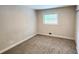 A simple bedroom with light beige walls and a window letting in natural light at 2653 Williamsburg Dr, Decatur, GA 30034