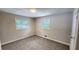 Neutral bedroom with plush carpeting, two windows, and ample natural light at 2653 Williamsburg Dr, Decatur, GA 30034