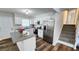 Open concept kitchen with white cabinets, stainless steel appliances, and island with granite countertops at 2653 Williamsburg Dr, Decatur, GA 30034