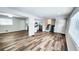Living room open to kitchen and stairs with newly finished floors and large windows at 2653 Williamsburg Dr, Decatur, GA 30034