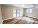 Bright living room with sliding glass doors, laminate flooring, and neutral paint at 2653 Williamsburg Dr, Decatur, GA 30034