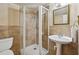 Bathroom featuring an enclosed shower, pedestal sink, and neutral wall tiles at 2805 Roxburgh Dr, Roswell, GA 30076