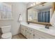 This bathroom features a double sink, a large framed mirror, and a view of the window at 2805 Roxburgh Dr, Roswell, GA 30076