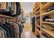 A walk-in closet with multiple shelves and hanging rods is pictured at 2805 Roxburgh Dr, Roswell, GA 30076