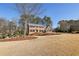 Front exterior of the traditional two-story brick home with a beautifully landscaped yard at 2805 Roxburgh Dr, Roswell, GA 30076