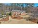 Stunning two-story brick home with a well-manicured front yard and mature trees at 2805 Roxburgh Dr, Roswell, GA 30076