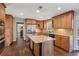 This kitchen has wood cabinets, an island with granite countertop, and stainless steel appliances at 2805 Roxburgh Dr, Roswell, GA 30076