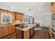 This kitchen has wood cabinets, an island with granite countertop, and stainless steel appliances at 2805 Roxburgh Dr, Roswell, GA 30076