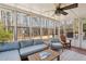 Bright sunroom with many windows overlooking the wooded backyard at 2805 Roxburgh Dr, Roswell, GA 30076