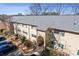 A ground-level, full, exterior view of a multi-Gathering brick apartment building with green shutters and a well-maintained yard at 3236 Henderson Mill Rd, Atlanta, GA 30341