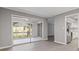 Open-concept dining area with sliding glass doors leading to a sunroom, stainless appliances, and wood floors at 3236 Henderson Mill Rd, Atlanta, GA 30341