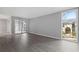 Bright living room showcasing wood floors, neutral walls, and a large window with views of the building exterior at 3236 Henderson Mill Rd, Atlanta, GA 30341