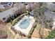 Aerial shot of a rectangular community pool with lounge chairs and a small pool house surrounded by trees and bushes at 3236 Henderson Mill Rd, Atlanta, GA 30341