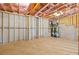 Spacious unfinished basement area with exposed framing, concrete foundation, and hot water tanks at 3255 Hilltop Cir, Marietta, GA 30066