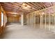 Unfinished basement with exposed wood framing, concrete floor, and natural light from a window at 3255 Hilltop Cir, Marietta, GA 30066