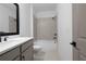 Bright bathroom featuring a tub with tile surround, modern vanity and neutral color palette at 3255 Hilltop Cir, Marietta, GA 30066