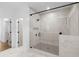 Modern bathroom with a glass shower featuring black hardware and tiled walls at 3255 Hilltop Cir, Marietta, GA 30066