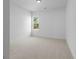 Bright bedroom with neutral carpet, white walls, and a window providing natural light at 3255 Hilltop Cir, Marietta, GA 30066