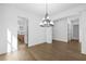 Open dining room with hardwood floors, chandelier, and view into kitchen at 3255 Hilltop Cir, Marietta, GA 30066
