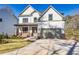 Charming home featuring a 2-car garage, covered porch, brick accents, and well-kept lawn at 3255 Hilltop Cir, Marietta, GA 30066