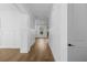 Bright hallway featuring hardwood floors, wainscoting and white trim at 3255 Hilltop Cir, Marietta, GA 30066