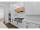Close up of a new kitchen featuring stainless steel appliances, white marble countertops, and white cabinets at 3255 Hilltop Cir, Marietta, GA 30066
